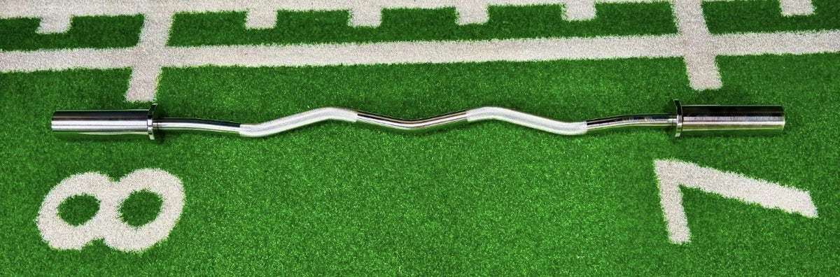 Complete chrome EZ curl bar showing both Olympic sleeves and angled grips on gym turf