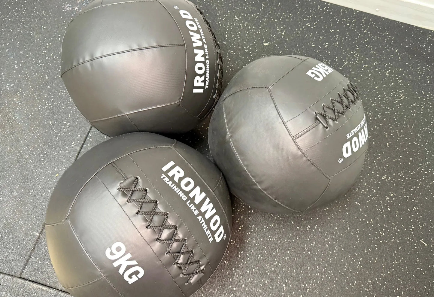 Photo showing real world photo of 3 9kg wall balls on a matting piece